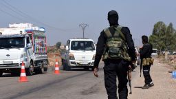 Syrian government security forces man a checkpoint along a road in southern Syria's Suwayda province on Saturday.