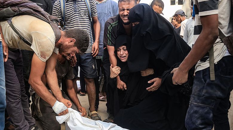 Palestinians grieve over the body of a man at the Nasser hospital on July 19, 2025. 