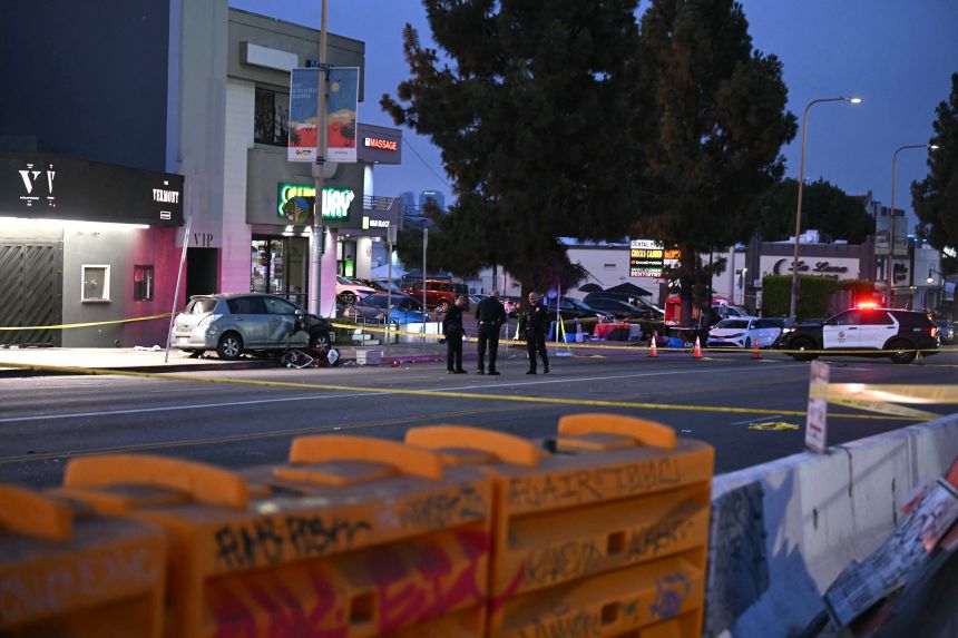 Officers stand at the scene near The Vermont Hollywood music venue after a vehicle drove into a crowd early Saturday.