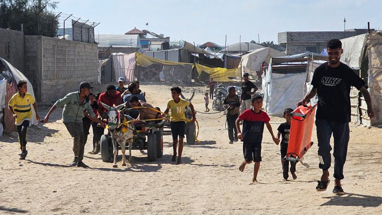 Palestinians in the southern Gaza Strip transport people who were injured while trying to get humanitarian aid on July 20, 2025. 