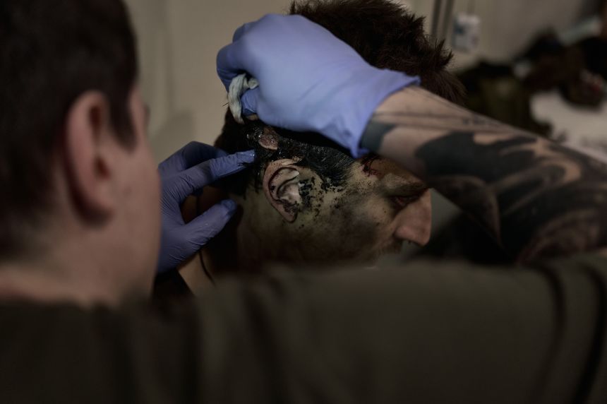 Medics from the "Ulf" unit of the "Da Vinci Wolves" battalion treat a wounded sodlier on July 20, 2025 in Dnipropetrovsk region, near Pokrovsk.