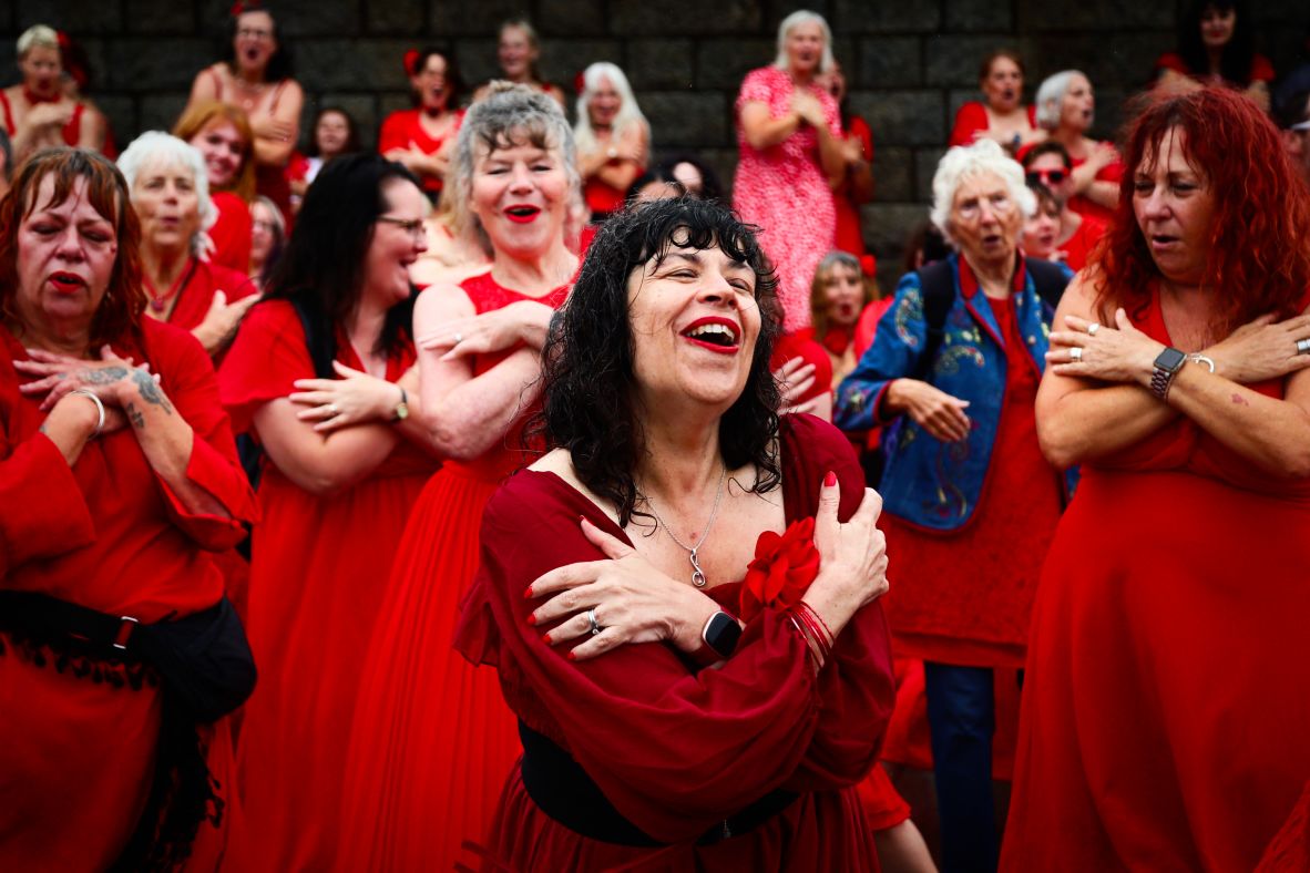 People gather in Folkestone, England, to dance to Kate Bush’s 1978 hit song “Wuthering Heights” on Sunday, July 20. They wore red dresses to re-enact <a  target="_top" href="/newspapers?url=https://www.youtube.com/watch?v=Fk-4lXLM34g" target="_blank">Bush’s iconic music video</a>.
