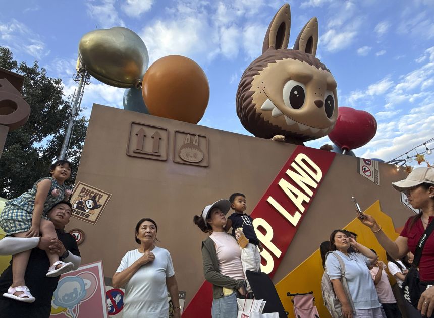 Visitors watch a performance of Pop Mart's hugely popular Labubu dolls series at the Pop Land theme park on July 16, 2025 in Beijing, China.