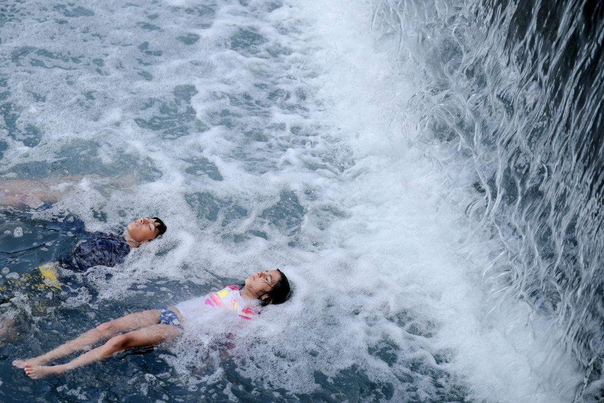Children cool off in the Yards Park canal basin in Washington, DC, on Thursday, July 17.