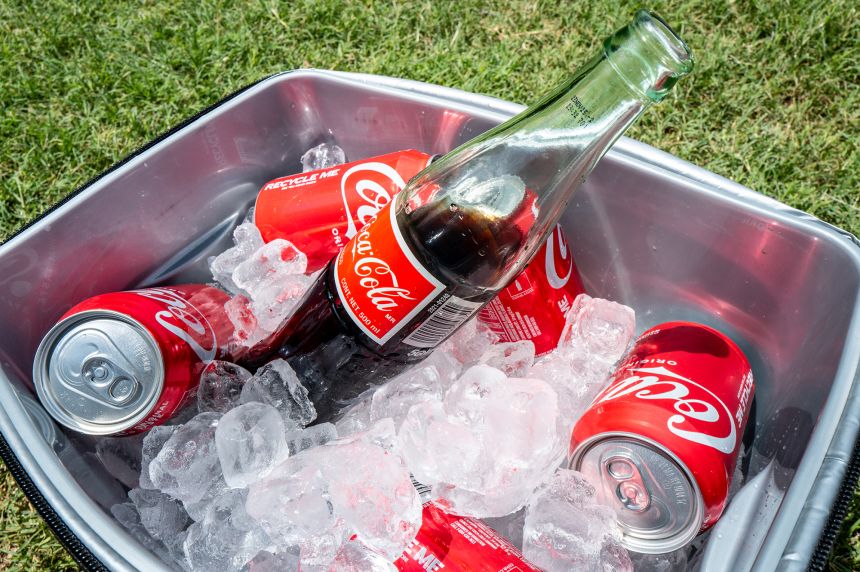Coke beverages are displayed in an ice cooler. President Donald Trump stated in a Truth Social post that Coca-Cola has agreed to use real cane sugar in its US beverages, similar to Mexican Coke.