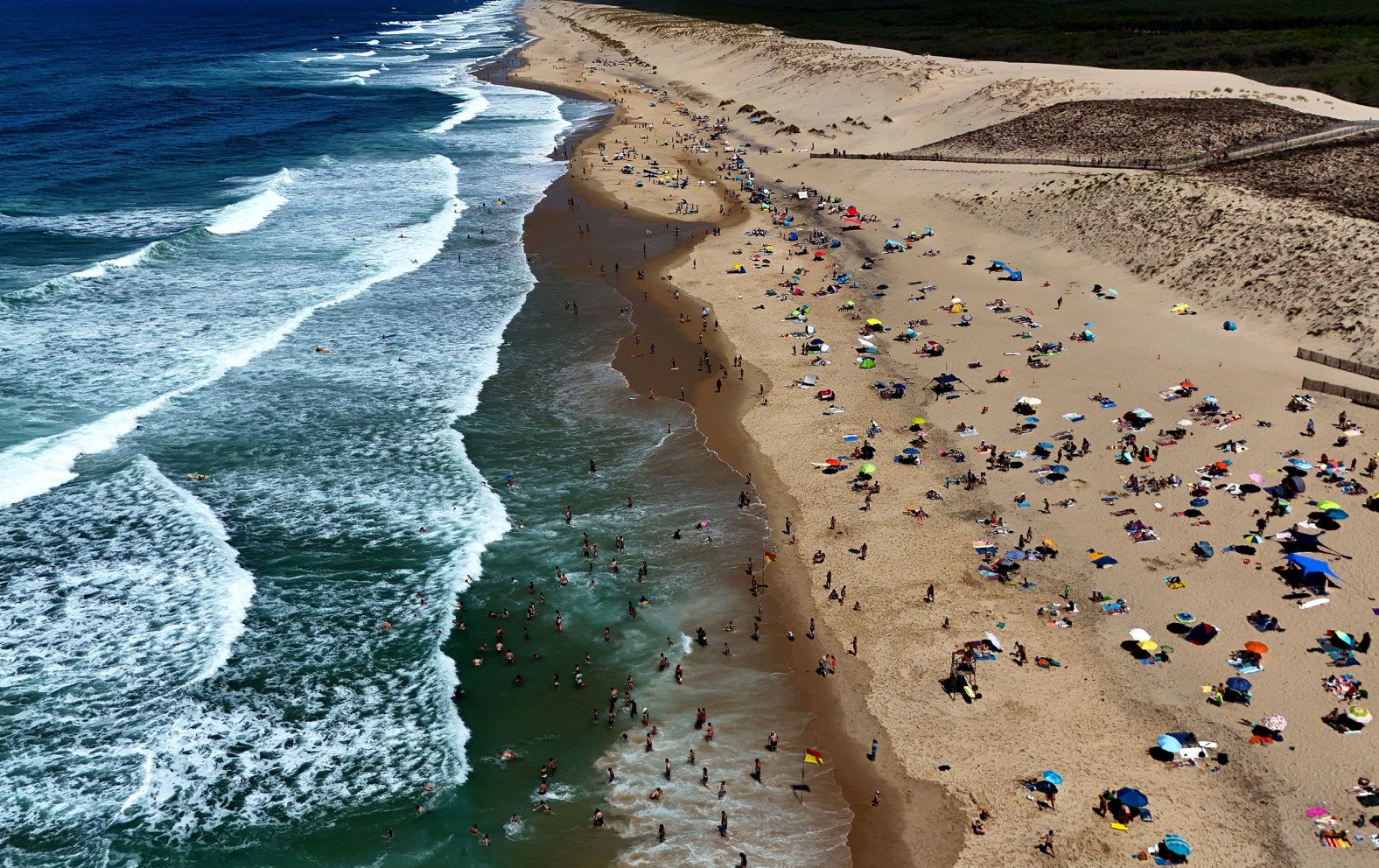 People enjoy the beach in Carcans, France, on Tuesday, July 22.