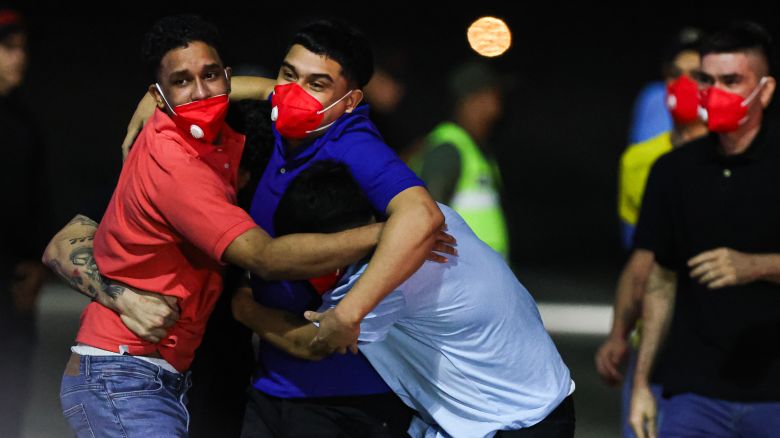 Detained Venezuelans embrace upon arrival at Simon Bolivar International Airport as part of a detainee exchange agreement between Venezuela and United States on July 18, 2025 in Caracas, Venezuela.