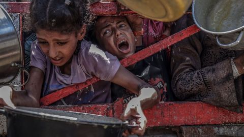 Young Palestinians wait for a charity organization to distribute food in Gaza City on July 24.