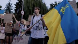 A protester shout slogans holding an Ukrainian national flag during a demonstration against a law that removes the independence of the NABU and SAPO anti-corruption agencies, in Kyiv on July 24, 2025, amid the Russian invasion of Ukraine. Ukraine's anti-corruption body NABU said a new bill submitted to parliament on July 24 would restore its independence, after President Volodymyr Zelensky backtracked under pressure from nationwide protests and the EU. (Photo by Tetiana DZHAFAROVA / AFP) (Photo by TETIANA DZHAFAROVA/AFP via Getty Images)          