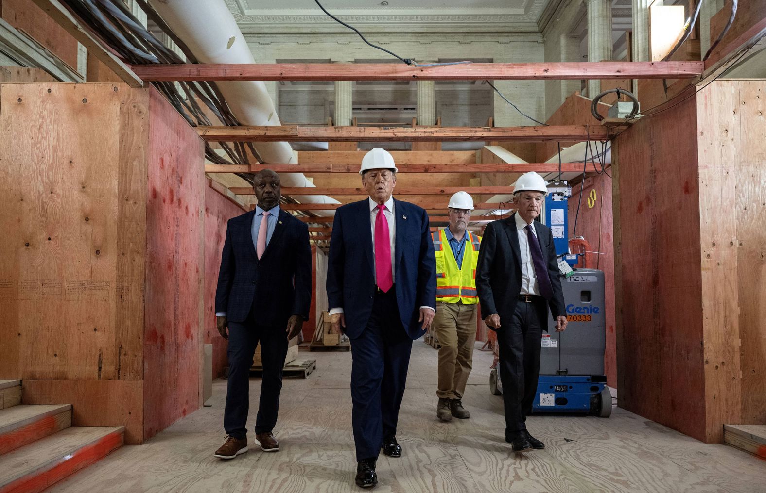 US President Donald Trump, second from left, tours the renovation site of the Federal Reserve headquarters in Washington, DC, on Thursday, July 24. He was joined by US Sen. Tim Scott, left, and Federal Reserve Chair Jerome Powell, right. The long-simmering clash between Trump and Powell <a href="index.php?page=&url=https%3A%2F%2Fwww.cnn.com%2F2025%2F07%2F24%2Fpolitics%2Ftrump-powell-federal-reserve-visit-renovation">was on full public display during the tour</a>.