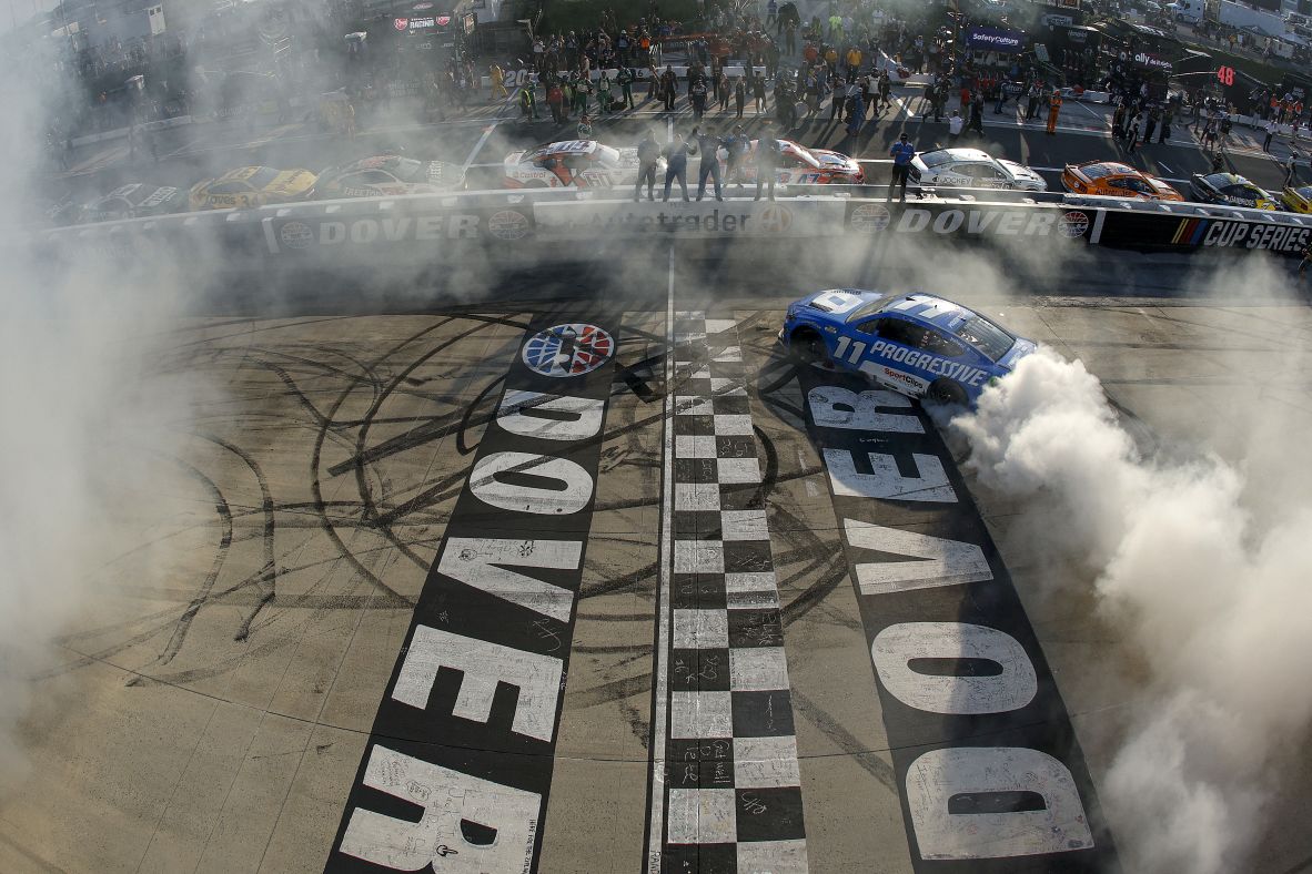 NASCAR driver Denny Hamlin celebrates with a burnout after he won a Cup Series race in Dover, Delaware, on Sunday, July 20.