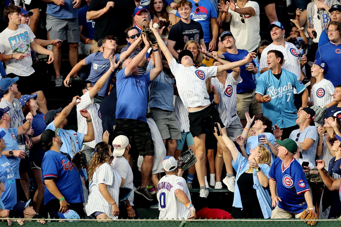 Fans catch a home run hit by Kansas City’s Salvador Perez during a Major League Baseball game at Chicago’s Wrigley Field on Monday, July 21.