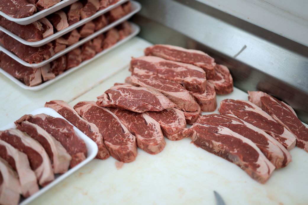 Beef is prepared for a customer at a grocery store in Miami, on July 22.