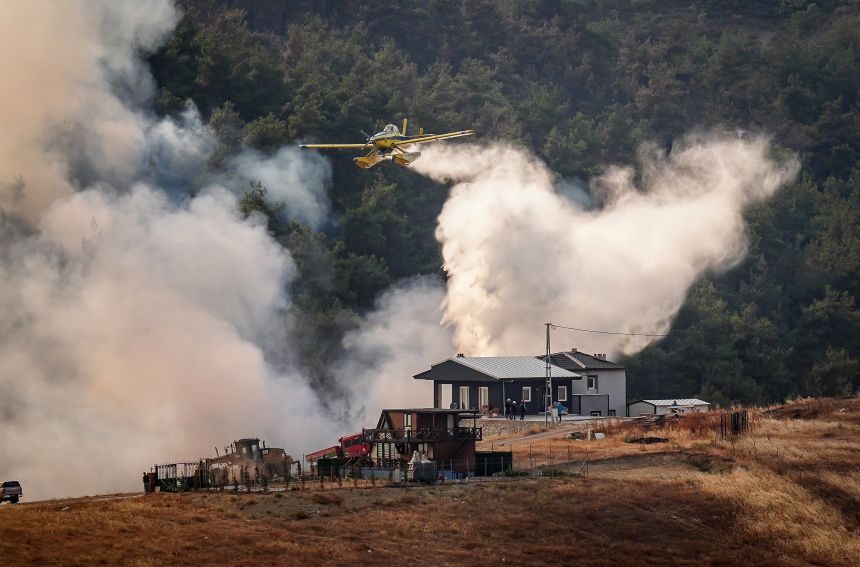Aircraft respond to a wildfire that reignited after it had been largely brought under control earlier in the morning, in the Orhaneli district of Bursa, Turkey, on Sunday. The fire spread rapidly again due to strong winds.