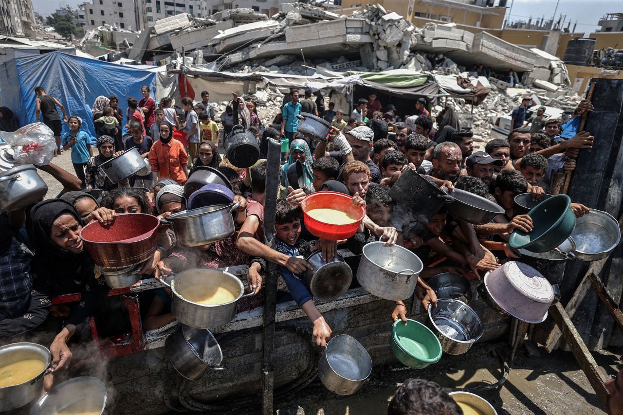 Palestinians facing food shortages receive aid in Gaza City on Monday.