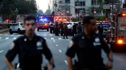 Police officers and emergency vehicles are seen in a street as police respond to a shooting incident in the Midtown Manhattan neighborhood of New York on July 28, 2025. Police swarmed Midtown Manhattan on Monday as the mayor of New York City said there was "an active shooter investigation" amid reports a police officer had been struck. New York City police commissioner Jessica Tisch said that the gunman, who had been on the loose in the busy Midtown district of Manhattan, had been "neutralized." (Photo by John Lamparski / AFP) (Photo by JOHN LAMPARSKI/AFP via Getty Images)