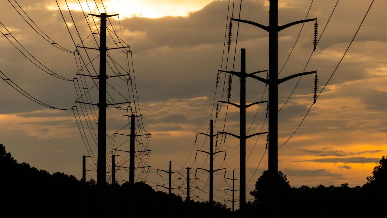 The sun sets behind utility lines during high temperatures in Columbia, South Carolina, US, on Monday, July 28, 2025. Nearly half the US will wilt under hot, sticky conditions through the bulk of the week as temperatures and humidity soar from Chicago to New York City and New Orleans, boosting power demand and raising health risks. Photographer: Sam Wolfe/Bloomberg via Getty Images