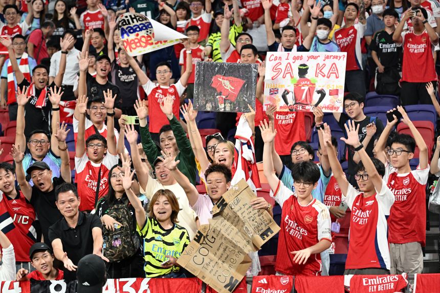 Arsenal supporters cheer on their team during a training session in Hong Kong on Wednesday.