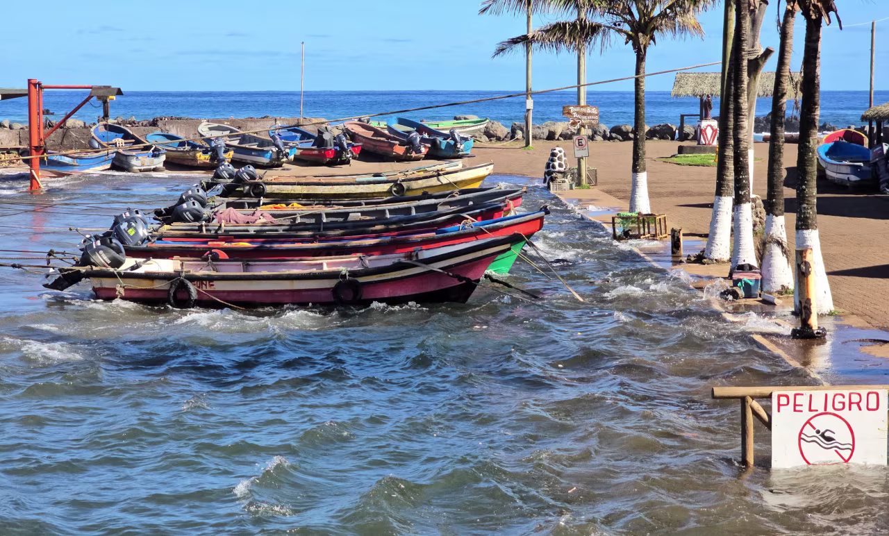 Waves hit boats moored at the dock during a tsunami warning in Easter Island, Chile on Wednesday.