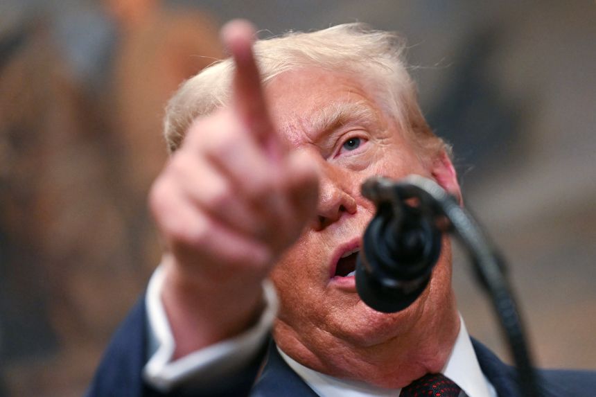 President Donald Trump points as he speaks after signing an executive order in the White House in Washington, DC, on July 31, 2025.