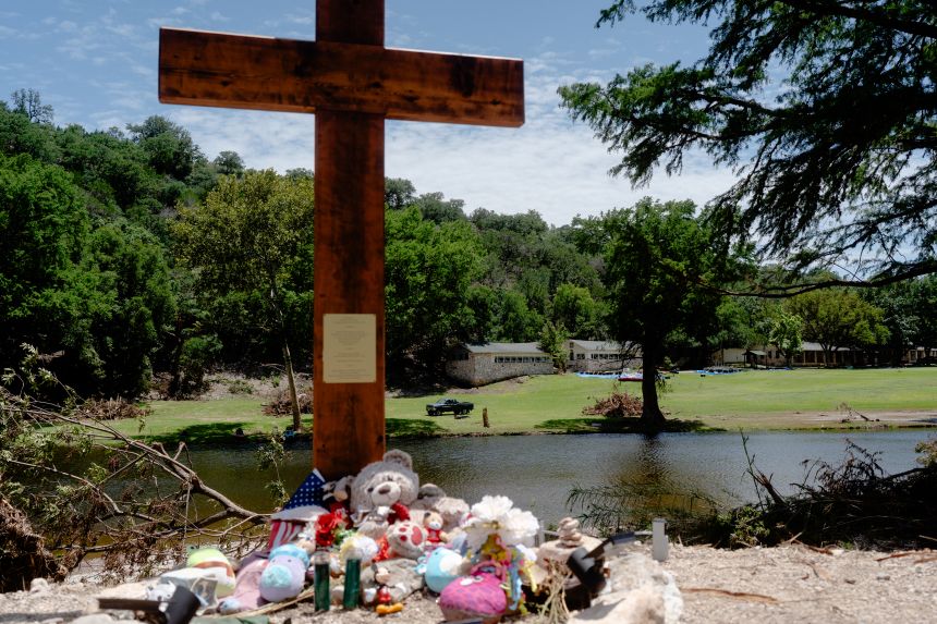 A 10-foot cross is seen along the banks of the Guadalupe River in front of Camp Mystic in Hunt, Texas, on July 18, 2025.