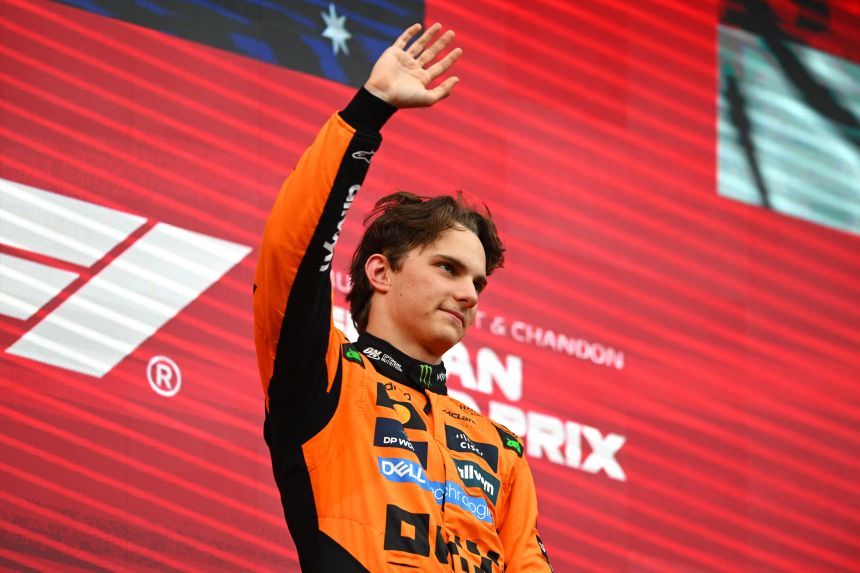 Race winner Oscar Piastri celebrates on the podium after winning the Belgian Grand Prix.