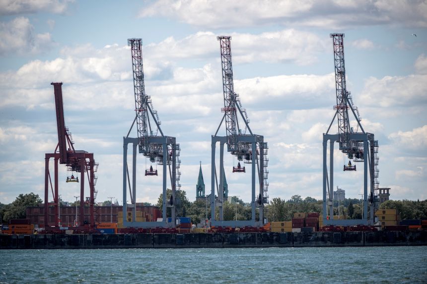 A crane is seen moving shipping containers at the Port of Montreal on August 1, 2025 in Montreal, Quebec, Canada.