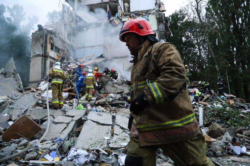 Rescue workers carry out a search and rescue operation at a destroyed residential building struck in a Russian drone-and-missile attack on July 31, 2025 in Kyiv, Ukraine.