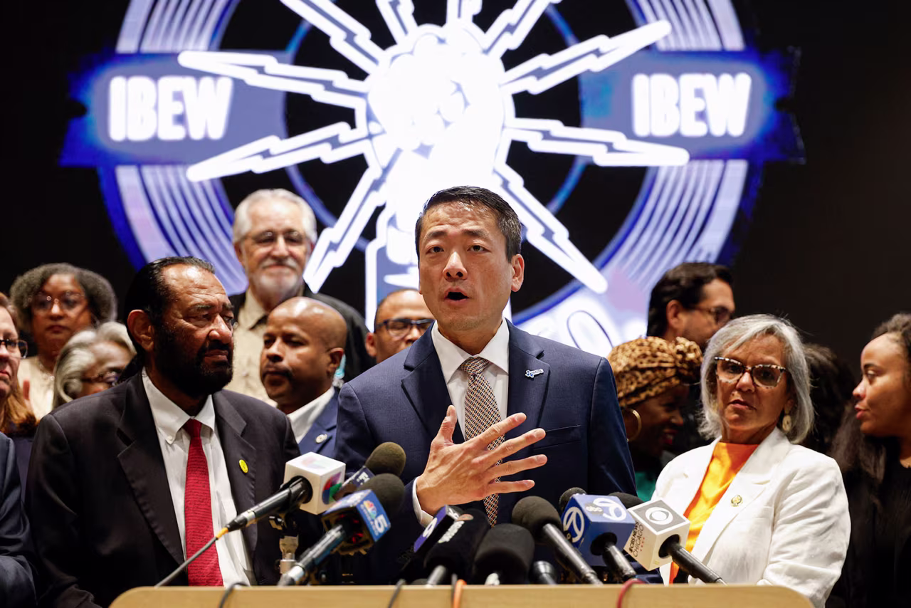 Texas Representative Gene Wu, center, speaks in front of Democratic members of Congress and Texas House Democrats during a news conference on Tuesday in Warrenville, Illinois.