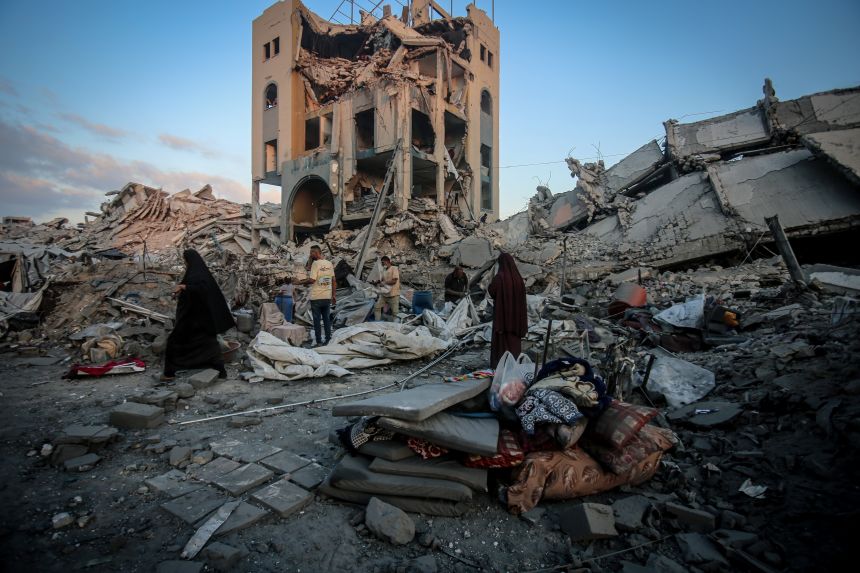 Palestinians make their way through the aftermath of an Israeli strike in the Sheikh Ridwan neighborhood of Gaza City, Gaza on August 06, 2025.