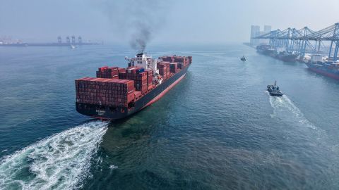 A container ship sails out of the port in Qingdao, in China's eastern Shandong province, on August 7.