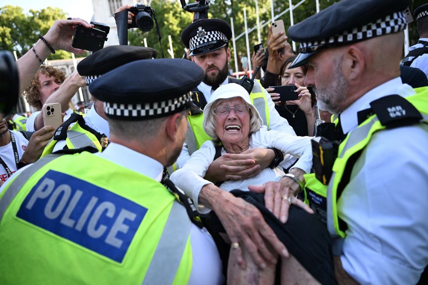 Police officers arrest an elderly protester at a "Lift The Ban" demonstration in support of Palestine Action, after its proscription, on August 9.