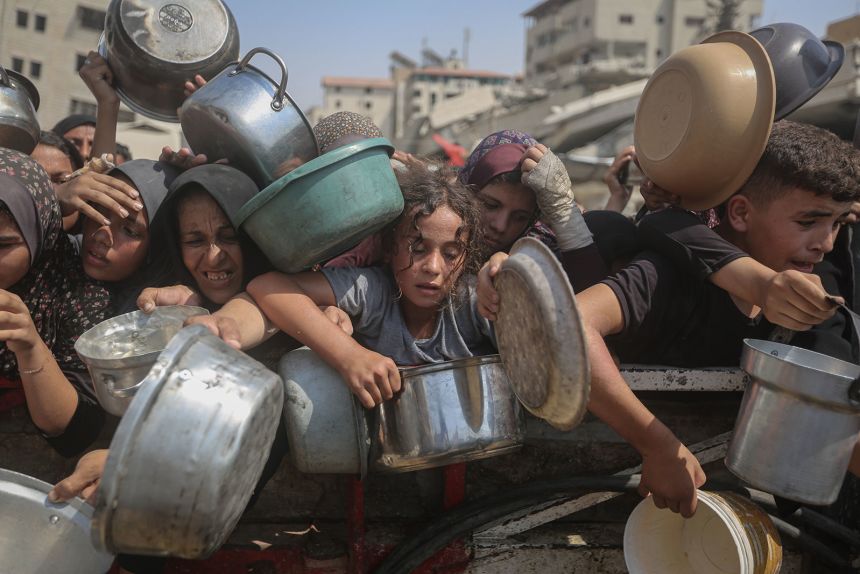 Starving Palestinians wait to receive food distributed by a charity organization on August 10, 2025, as Israel continues to block humanitarian aid from reaching Gaza.