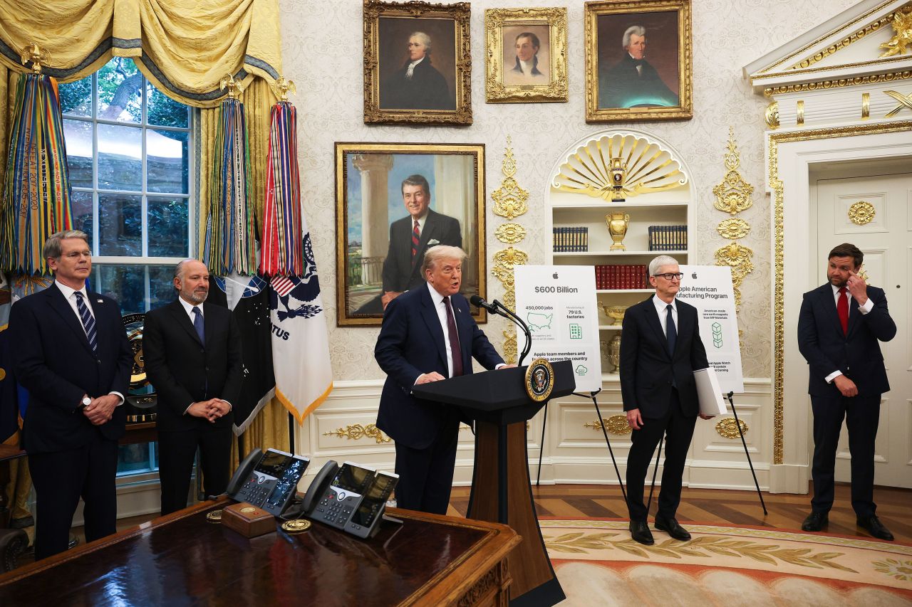 President Donald Trump speaks during an event with Apple CEO Tim Cook, second from right, in the Oval Office of the White House in Washington, DC, on Wednesday.