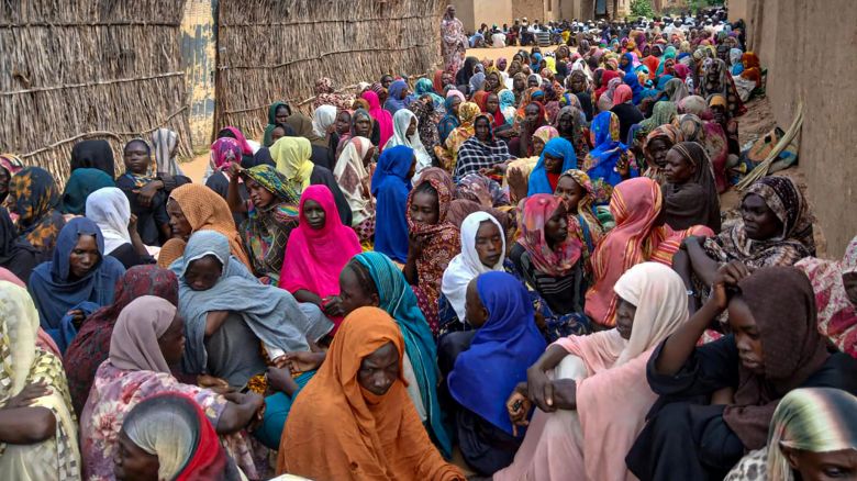 Sudanese residents gather to receive free meals in El Fasher, a city besieged by Sudan's paramilitary Rapid Support Forces (RSF) for more than a year, in Darfur region, on August 11, 2025.