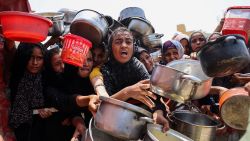 Palestinians gather to receive cooked meals from a food distribution center in Gaza City on August 13, 2025. Israeli military said on August 13 it had approved the framework for a new offensive in the Gaza Strip, as Hamas condemned what it called "aggressive" Israeli ground incursions in Gaza City. The approval for the expanded offensive comes days after Israel's security cabinet called for the seizure of Gaza's largest city, following 22 months of war that have created dire humanitarian conditions in the Palestinian territory. (Photo by Omar AL-QATTAA / AFP) (Photo by OMAR AL-QATTAA/AFP via Getty Images)          