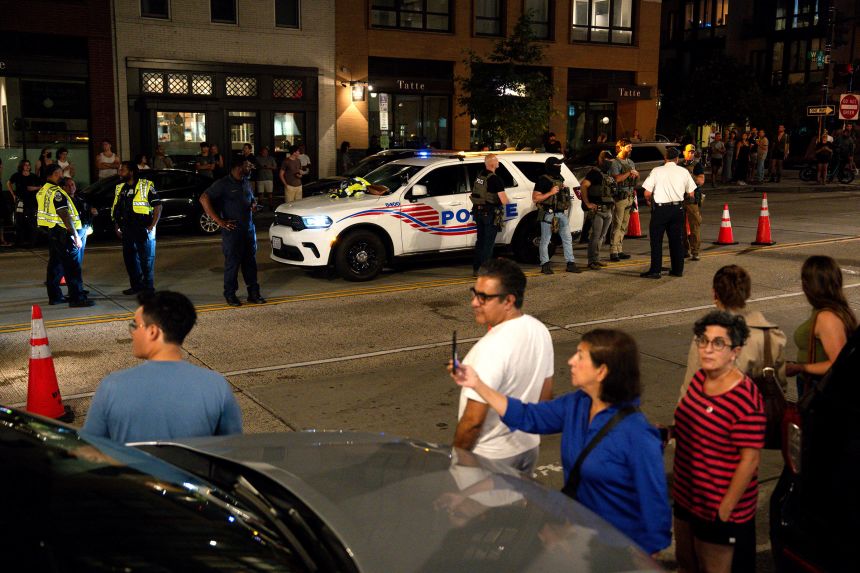 A crowd forms on the sidewalks near a security checkpoint on 14th Street in Washington, DC, on Wednesday night.