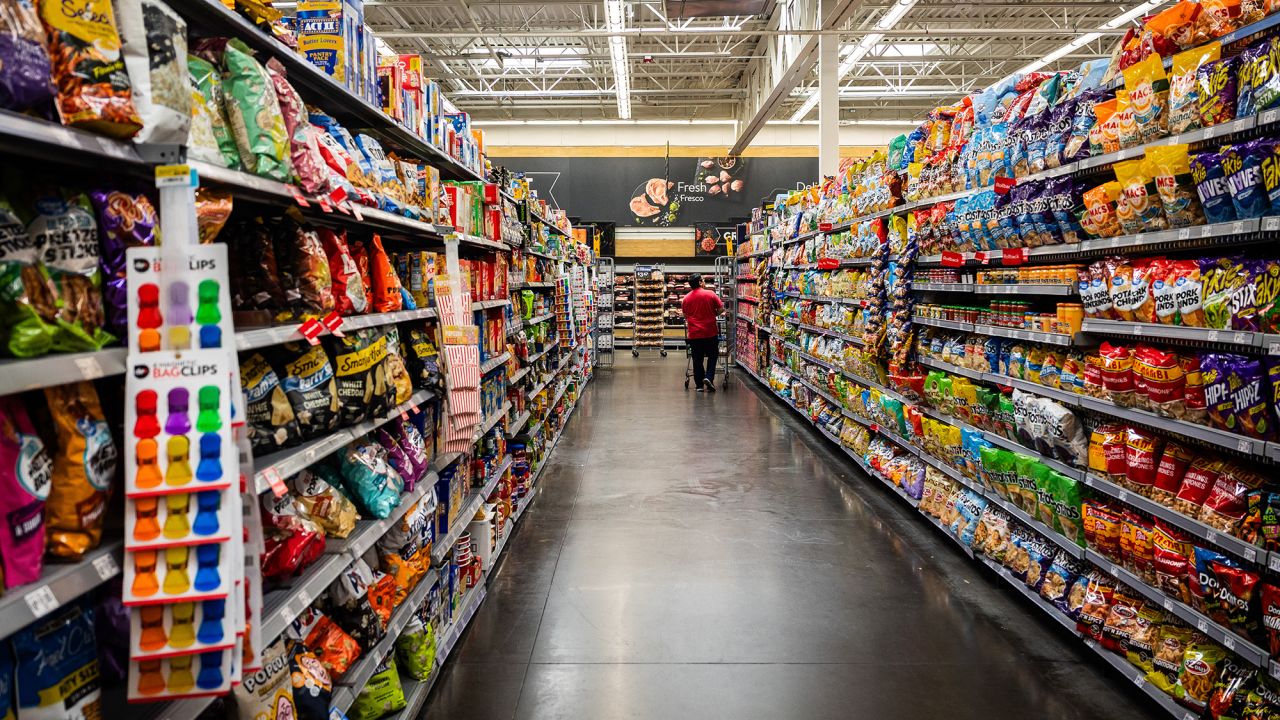 Customer with shopping cart in the snack aisle of a Walmart store in Florida City on August 5, 2025.
