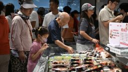 Customers purchase sushi at a supermarket on August 9, 2025 in Beijing, China.