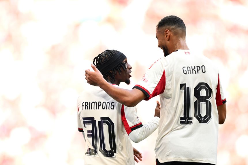Jeremie Frimpong celebrates scoring his  goal with Cody Gakpo.