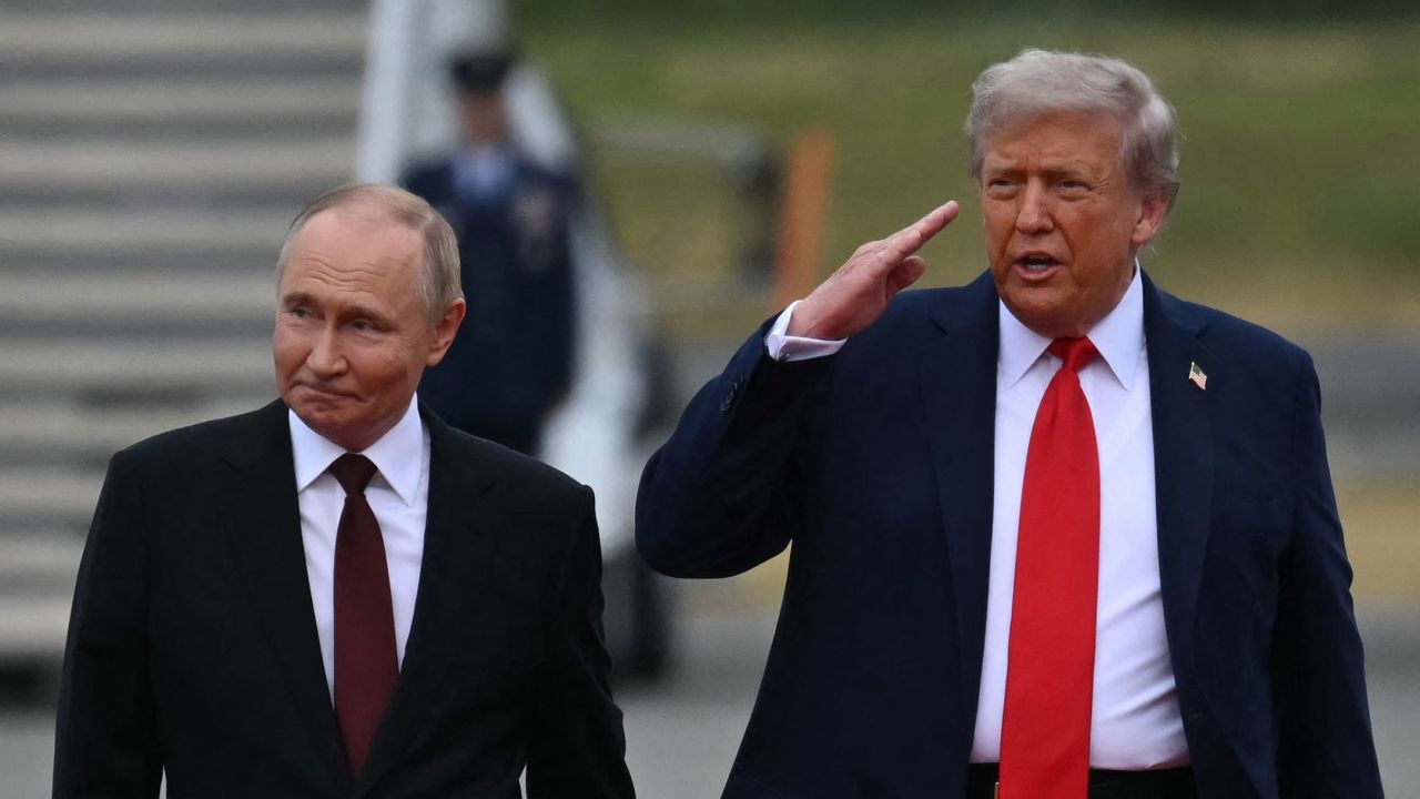US President Donald Trump salutes as he walks with Russian President Vladimir Putin on the tarmac after they arrived at Joint Base Elmendorf-Richardson in Anchorage, Alaska, on August 15, 2025. Putin is in Alaska at the invitation of Trump in his first visit to a Western country since he ordered the 2022 invasion of Ukraine that has killed tens of thousands of people. (Photo by ANDREW CABALLERO-REYNOLDS / AFP) (Photo by ANDREW CABALLERO-REYNOLDS/AFP via Getty Images)          
