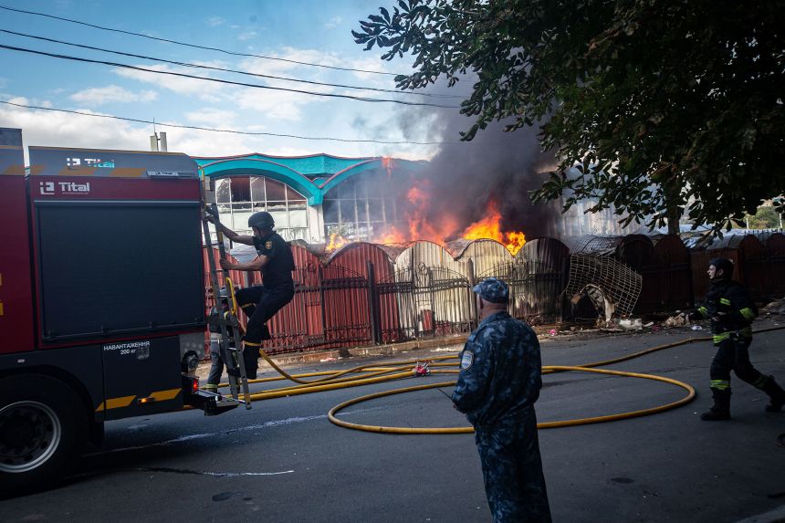 Emergency services workers extinguish a fire, causeed by the explosion of a Russian drone, at the central market in Sumy, Ukraine, earlier in the day on Friday.