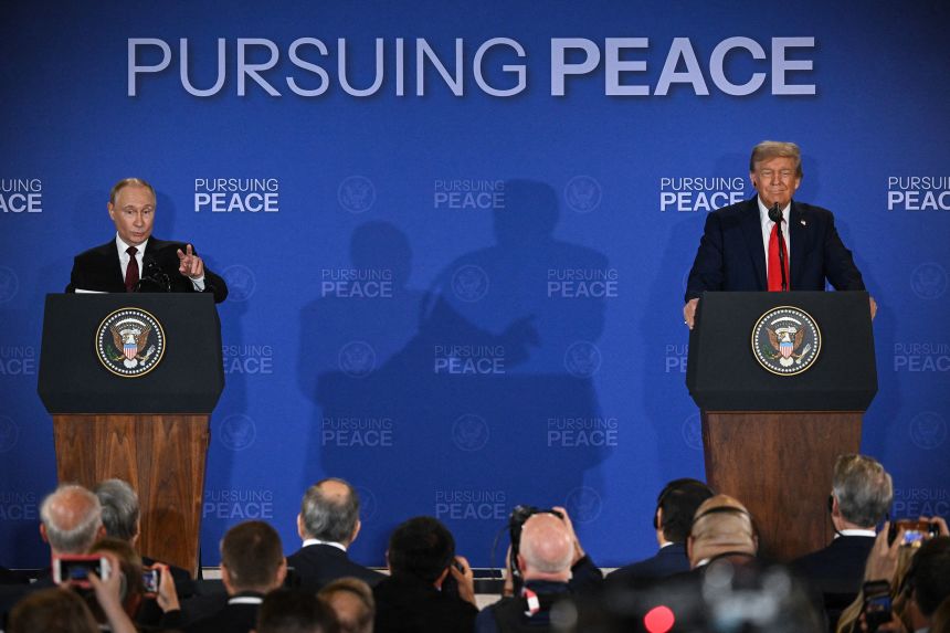 US President Donald Trump, right, reacts as Russian President Vladimir Putin speaks during a joint press conference following their summit at Joint Base Elmendorf-Richardson in Anchorage, Alaska, on August 15.