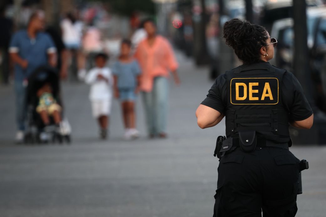 Drug Enforcement Administration (DEA) agent patrols on Constitution Avenue near the Washington Monument on the National Mall following the announcement of a federal takeover of DC police and mobilization of the National Guard from Donald Trump on August 11, 2025.