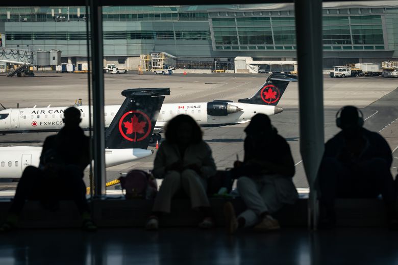 Passengers wait at Toronto Pearson International Airport in Mississauga, Ontario, Canada, in August.