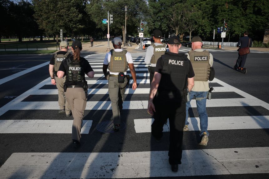 Members of the Drug Enforcement Administration (DEA) patrol the National Mall area on August 12, 2025, in Washington, DC.