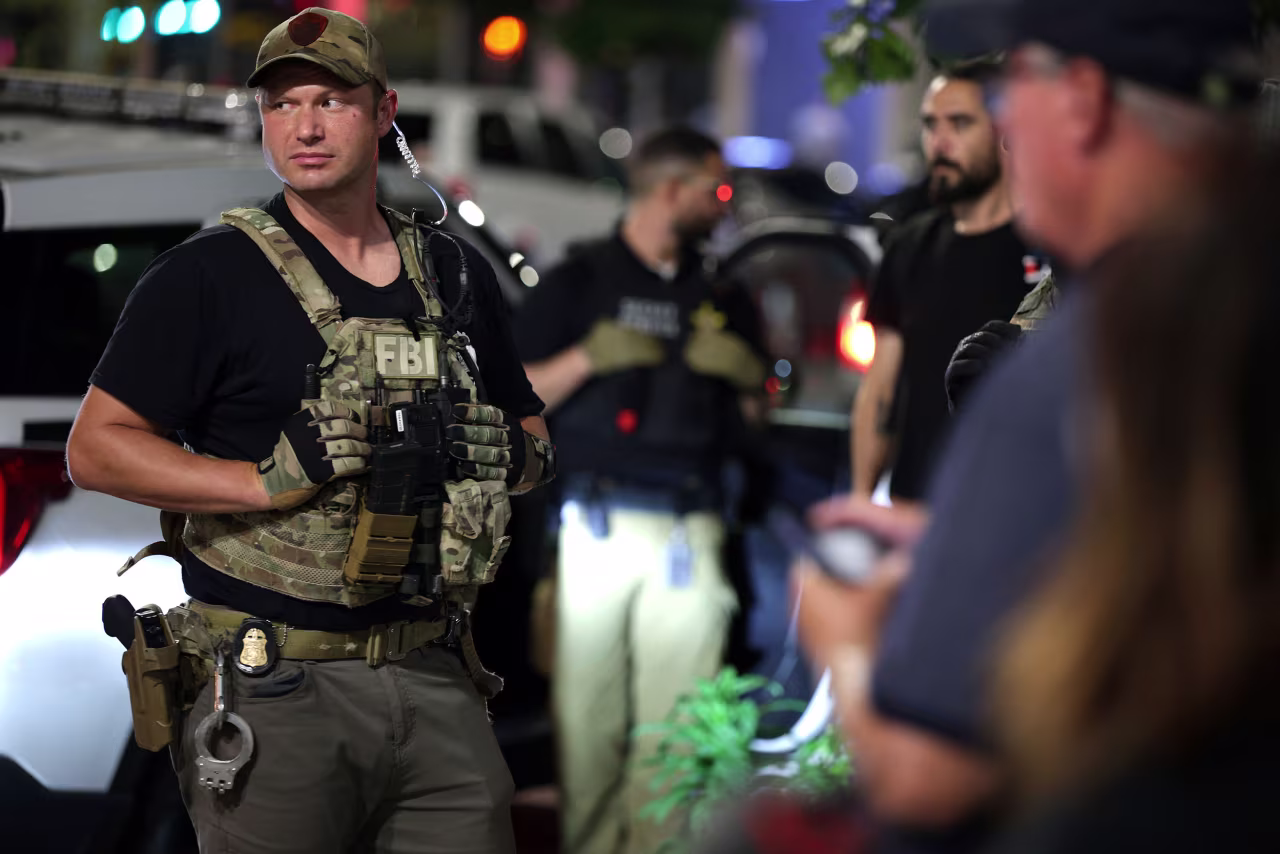 Federal agents stand at the scene of an arrest outside New York Avenue Presbyterian Church on August 14 in Washington, DC.