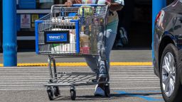 A shopper pushes a cart outside a Walmart store in San Leandro, California, US, on Tuesday, Aug. 19, 2025.