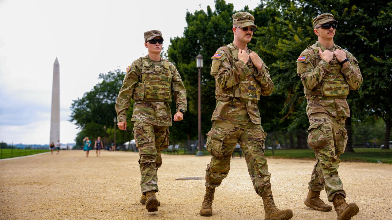 National Guard troops walk along the National Mall on August 20, 2025 in Washington, DC.