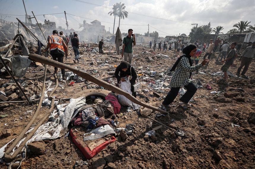 A view of the destroyed camp, which houses displaced Palestinians, after Israeli army targeted the camp as Palestinians gather to inspect the site in Deir Al Balah, Gaza on Thursday.